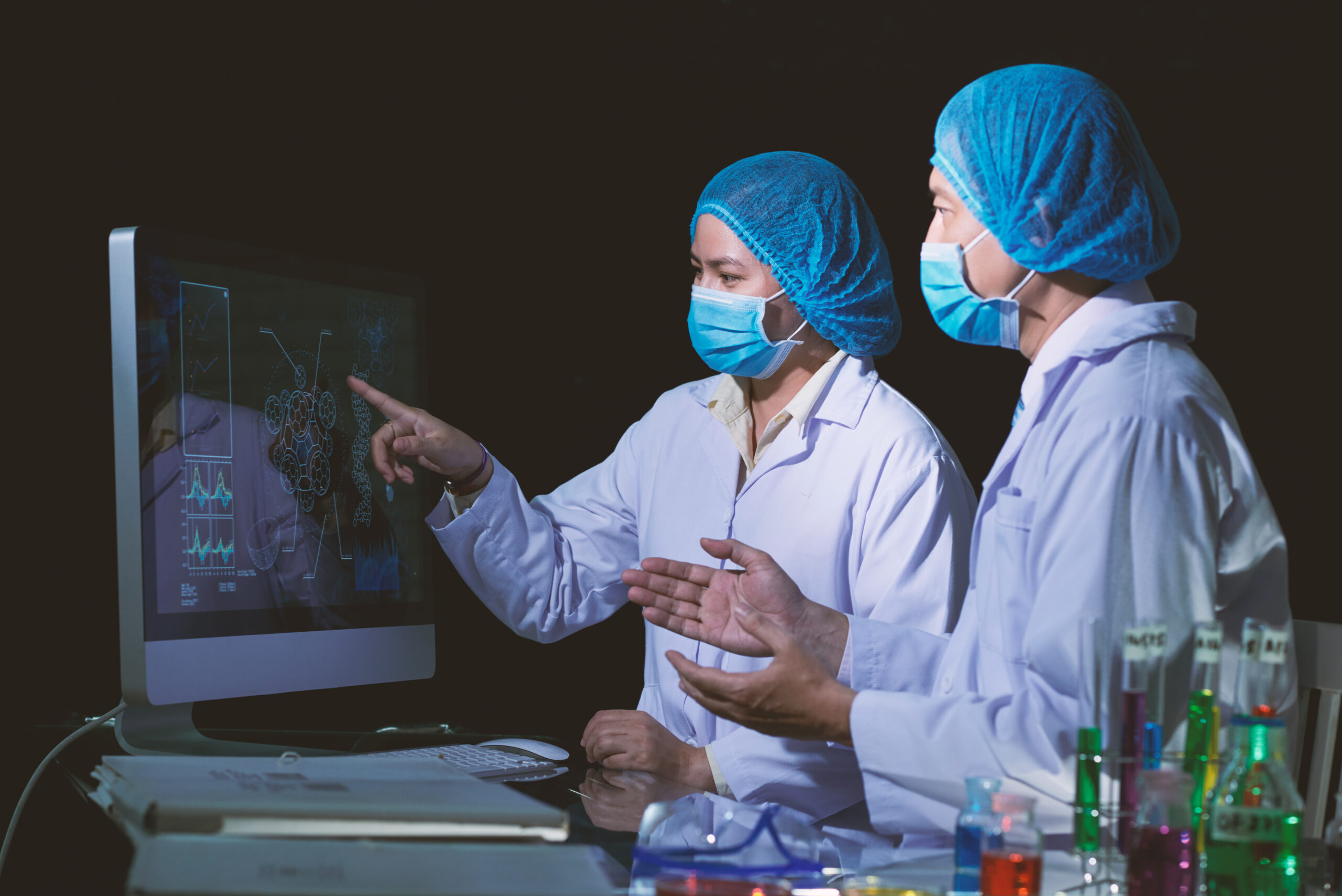 Two scientists reviewing computer data | Worldwide medical services UK